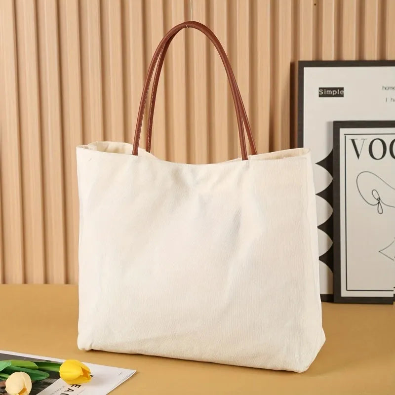 Beige white canvas tote bag with detachable crossbody strap, side bottle pockets, and a front zipped compartment.