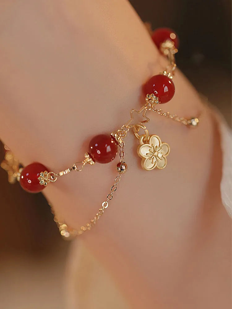 Women's red agate bracelet with double layer design and floral charms