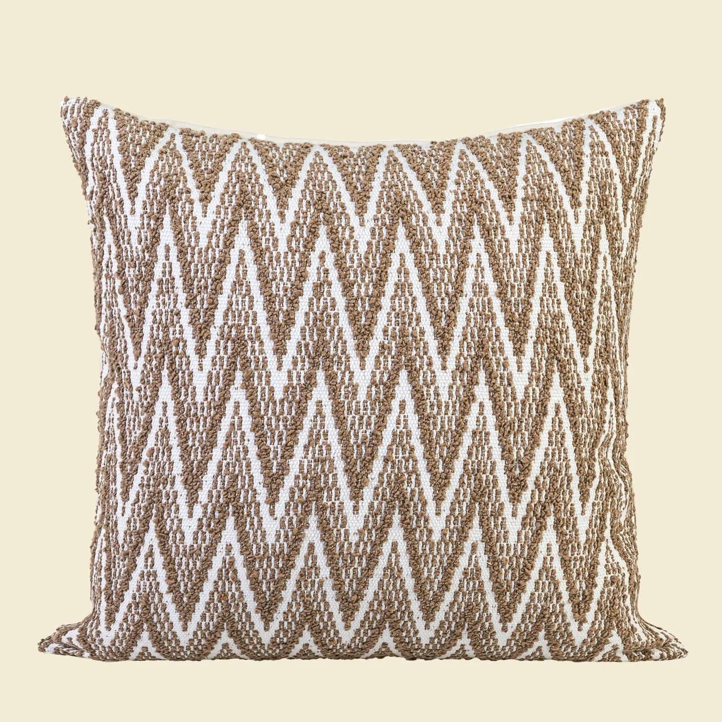 Chinese style square cushion in brown Maillard colour on a sofa.