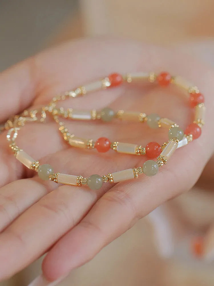 Casual women's bamboo joint bracelet made from 6mm Hetian jade beads in jade or red.