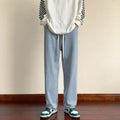Men's loose cotton sports jeans in retro blue with zipper fly, side view on model