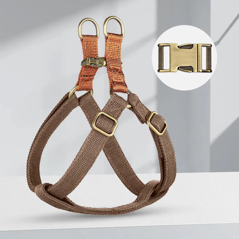 Brown vest-style anti-loss dog harness and lead fastened on a small dog.