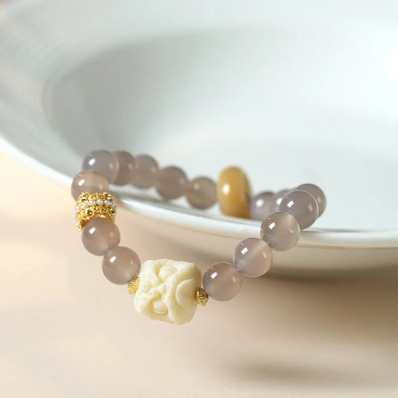 Hand-woven bracelet with 10mm round gray agate and mellite beads, Ivory Xingshi style, unisex design.