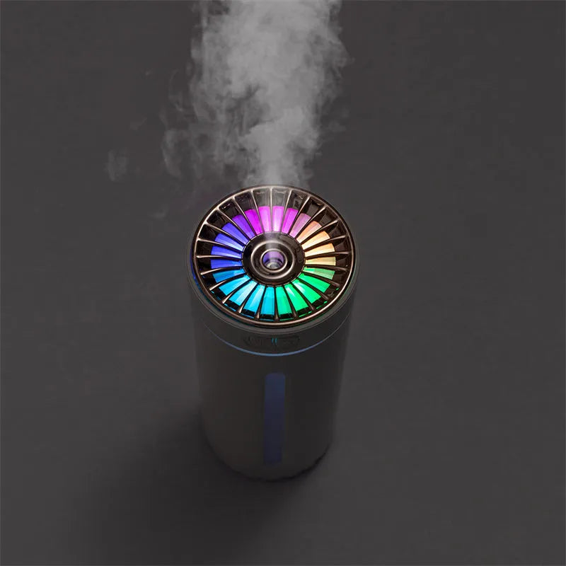 Black wireless portable humidifier with colourful lights beside car cup holder