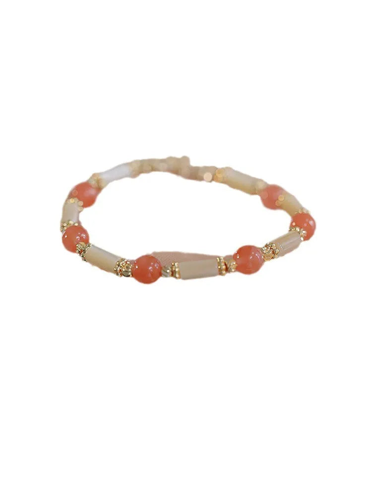 Casual women's bamboo joint bracelet made from 6mm Hetian jade beads in jade or red.