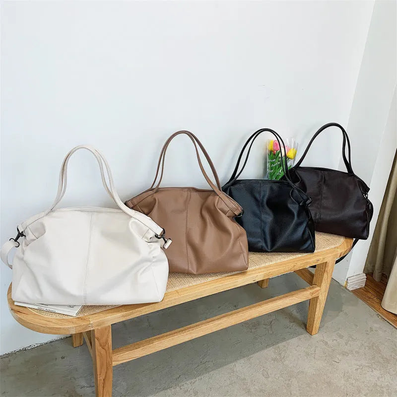 Large soft surface PU messenger tote bag in black with adjustable shoulder strap and zipper opening.