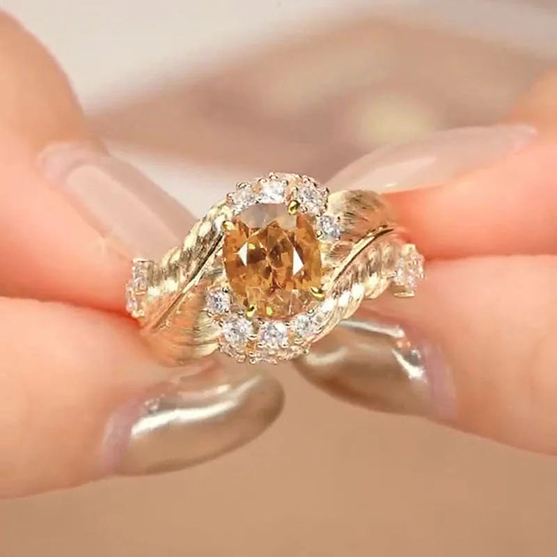 Women's gold embossed feather ring with geometric design and yellow zircon stones