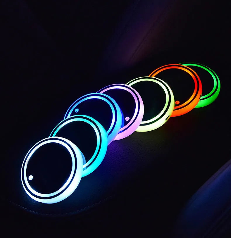 Colourful LED light-up coaster for a car cup holder showing multiple light colours on a 68mm acrylic and ABS mat.