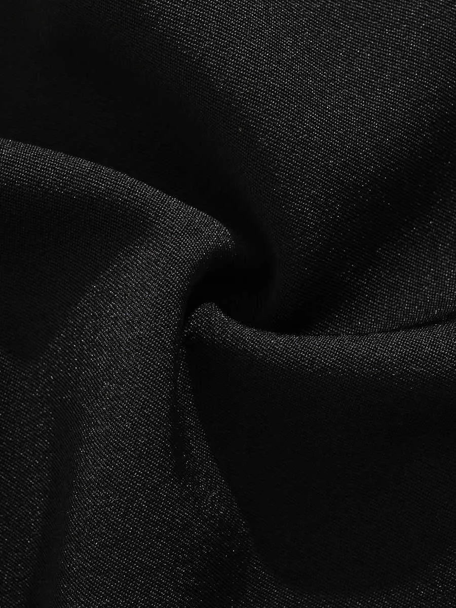 Man wearing black semi-elastic loose-fit shorts with a colour button fastening and zipper fly