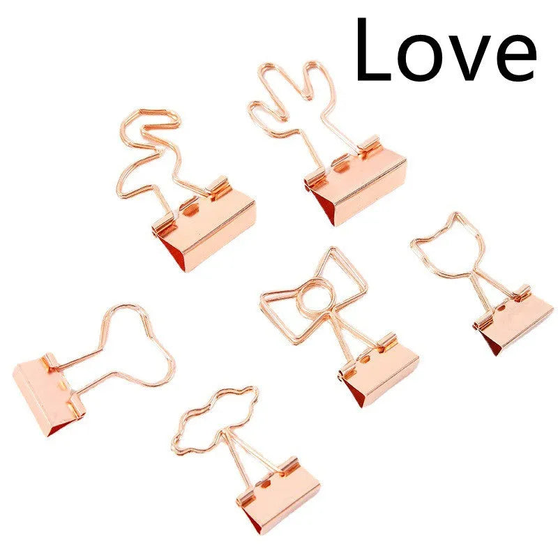 Gold-coloured long tail metal clip with a choice of flamingo, love, clouds, cat, cactus, or bow decorative design.