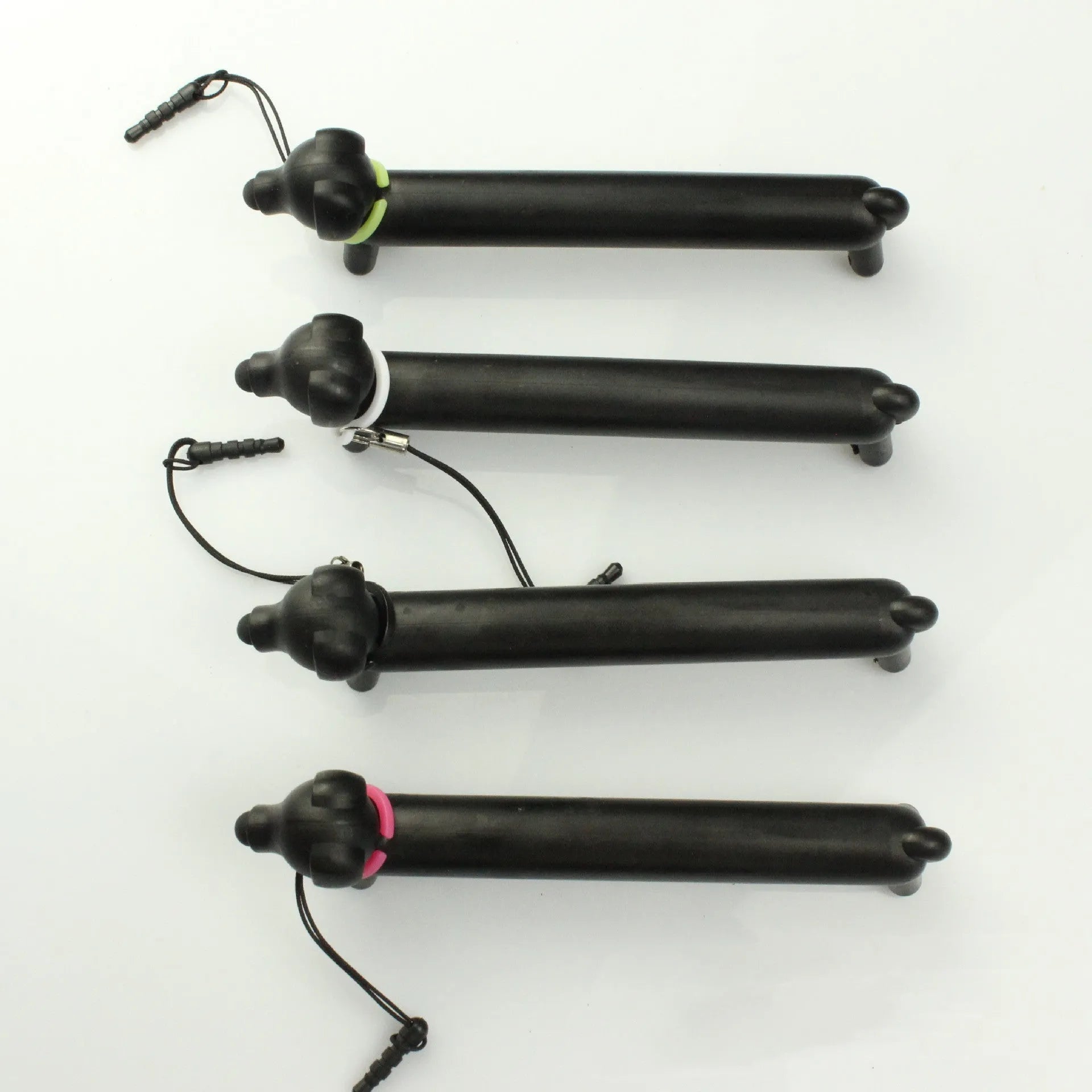 Black dog-shaped touch screen stylus shown with phone holder configuration