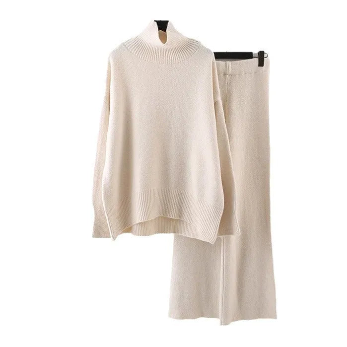 Women's beige acrylic knit long-sleeve sweater and matching wide-leg trousers set on a hanger.