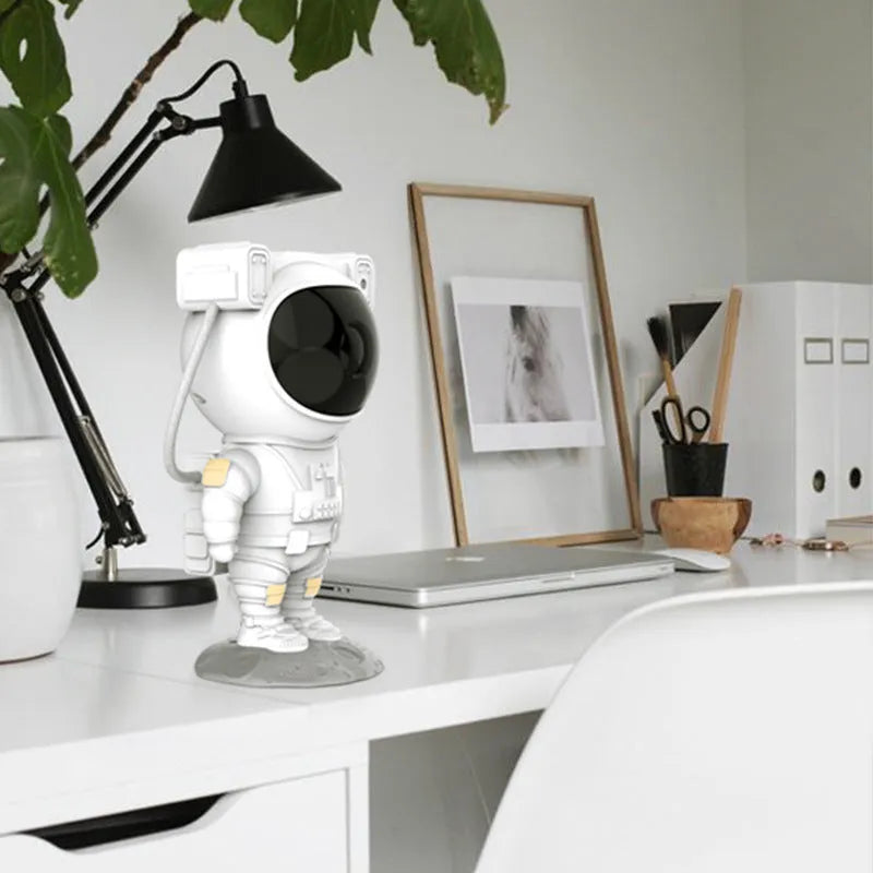 Small astronaut-shaped night light projecting starry laser atmosphere with white light, PVC shade, USB powered