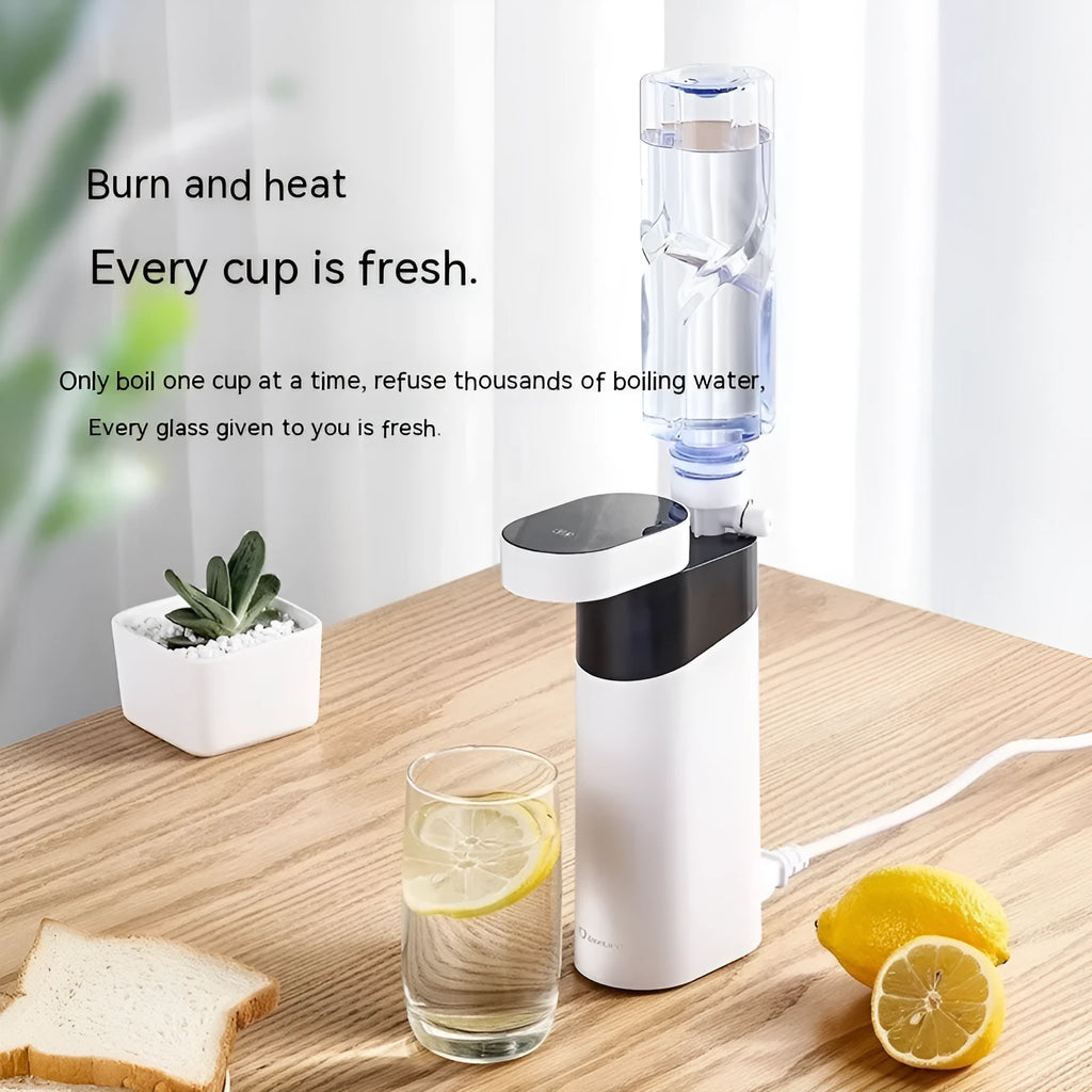 Small black instant water dispenser with digital display on a desktop.