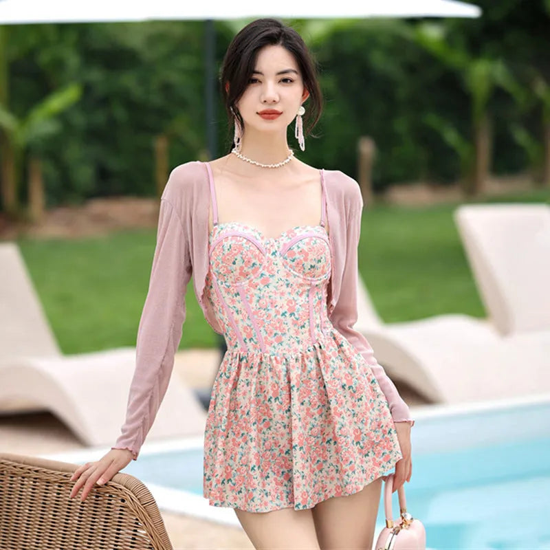 Women's pink floral one-piece jumpsuit swimsuit with suspender straps on hanger