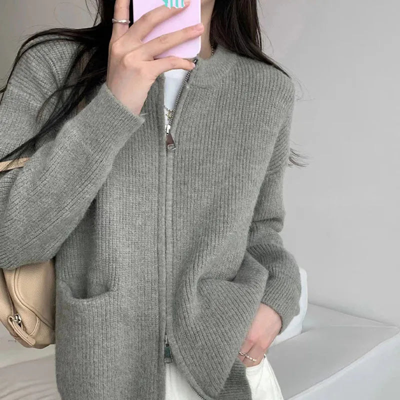 Beige temperature-sensitive viscose sweater coat, long sleeve cardigan style on a hanger.