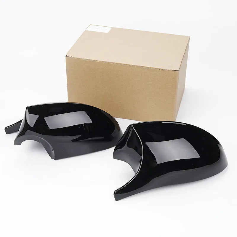 Pair of black ABS plastic rearview mirror shells for BMW 3 Series E90 car.