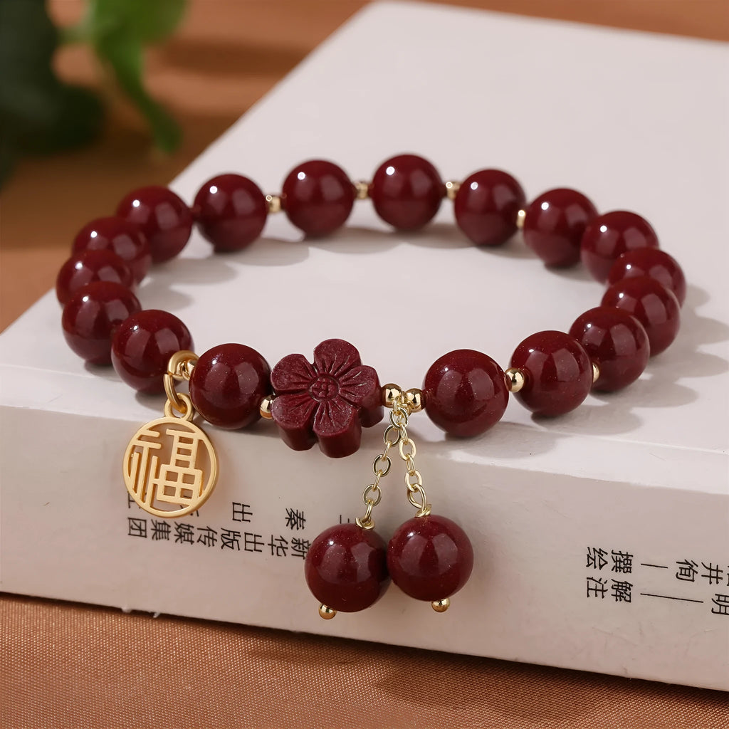 Women's purple gold sand fu character bracelet with peach blossom tassel detailing and handcrafted cinnabar construction
