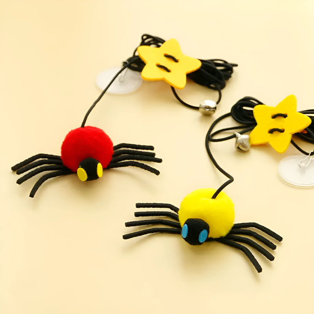 Red and yellow hanging cat toy with elastic rope, feather ball, bell and spider attachment for door mounting